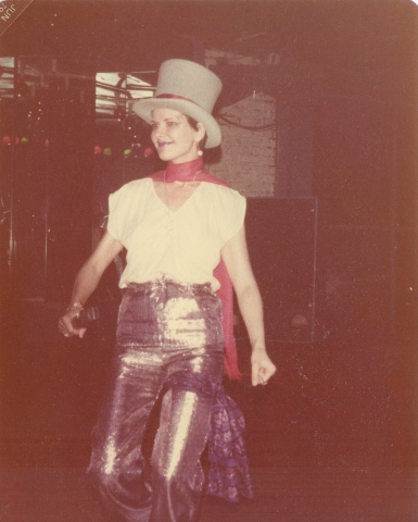 Dr. Nancy Mroczek with a tall hat performing.